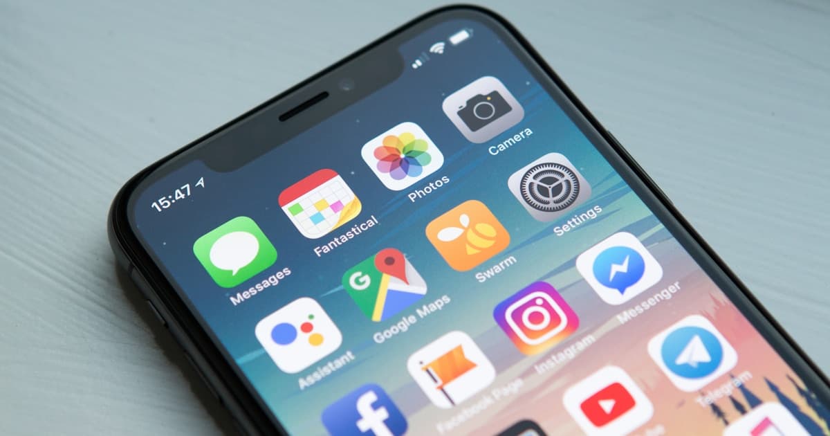 Smartphone displaying a clean mobile website layout next to a laptop on a desk