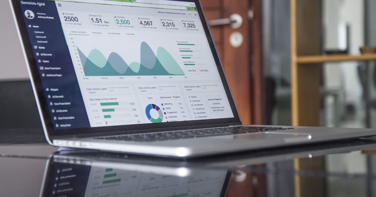Marketing analytics dashboard showing SEO performance metrics and cost data on a laptop screen