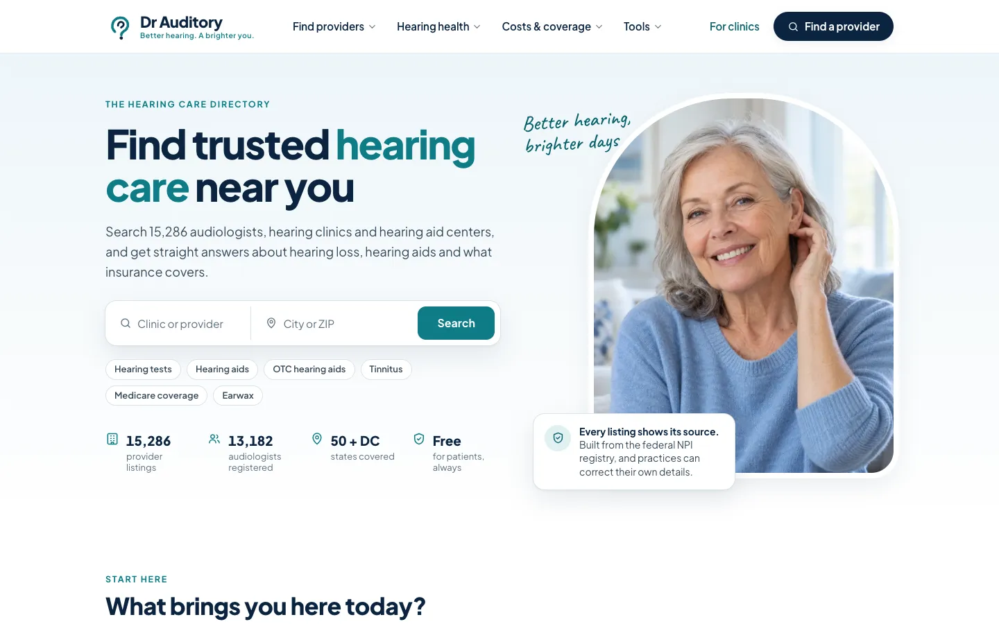 Dr Auditory homepage with the headline Find trusted hearing care near you, a clinic and city search bar, provider counts, and a photo of a smiling older woman